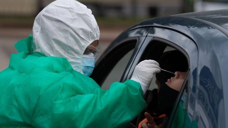 A person undergoes a PCR test for COVID-19 at a testing facility set up in front of the Uruguayan Congress in Montevideo on December 18, 2020, amid the novel coronavirus pandemic. - The Uruguayan Senate on Friday approved a bill to limit the right to assembly, following a spike in the number of COVID-19 cases in the South American country. (Photo by Pablo PORCIUNCULA / AFP) (Photo by PABLO PORCIUNCULA/AFP via Getty Images)