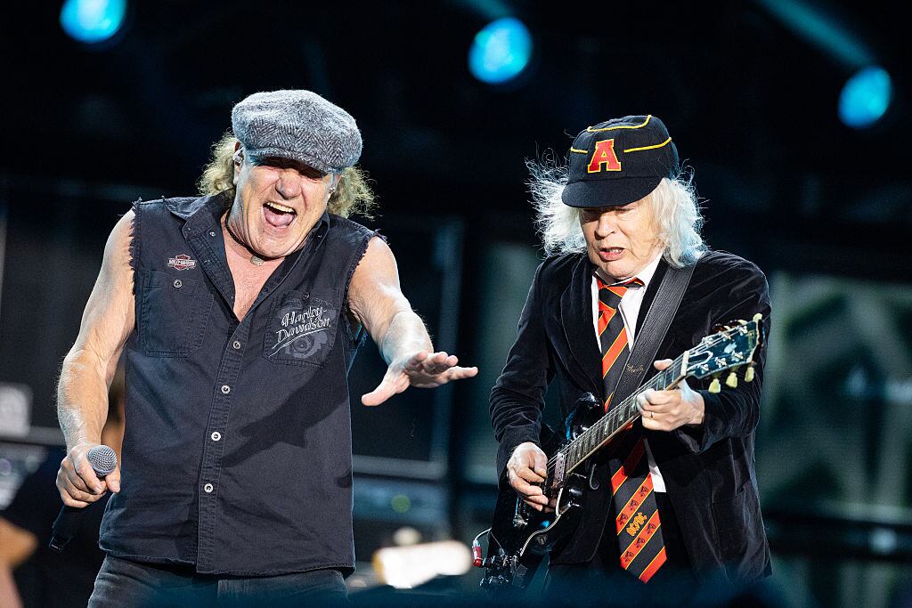 DUESSELDORF, GERMANY - JULY 08: Singer Brian Johnson (L) and musician Angus Young of AC/DC perform onstage during the AC/DC PWR UP Europe tour at Merkur Spiel-Arena on July 08, 2025 in Duesseldorf, Germany. (Photo by Andreas Rentz/Getty Images)
