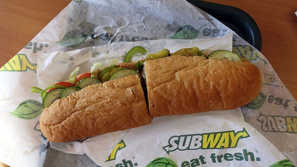 MIAMI, FL - OCTOBER 21:  A Subway sandwich is seen in a restaurant as the company announced a settlement over a class-action lawsuit that alleged that Subway engaged in deceptive marketing for its 6-inch and 12-inch sandwiches and served customers less food than they were paying for on October 21, 2015 in Miami, Florida. While it denies the claims, Subway said that franchisees would be required to have a measurement tool in stores to make sure loaves are 12-inches.  (Photo by Joe Raedle/Getty Images)