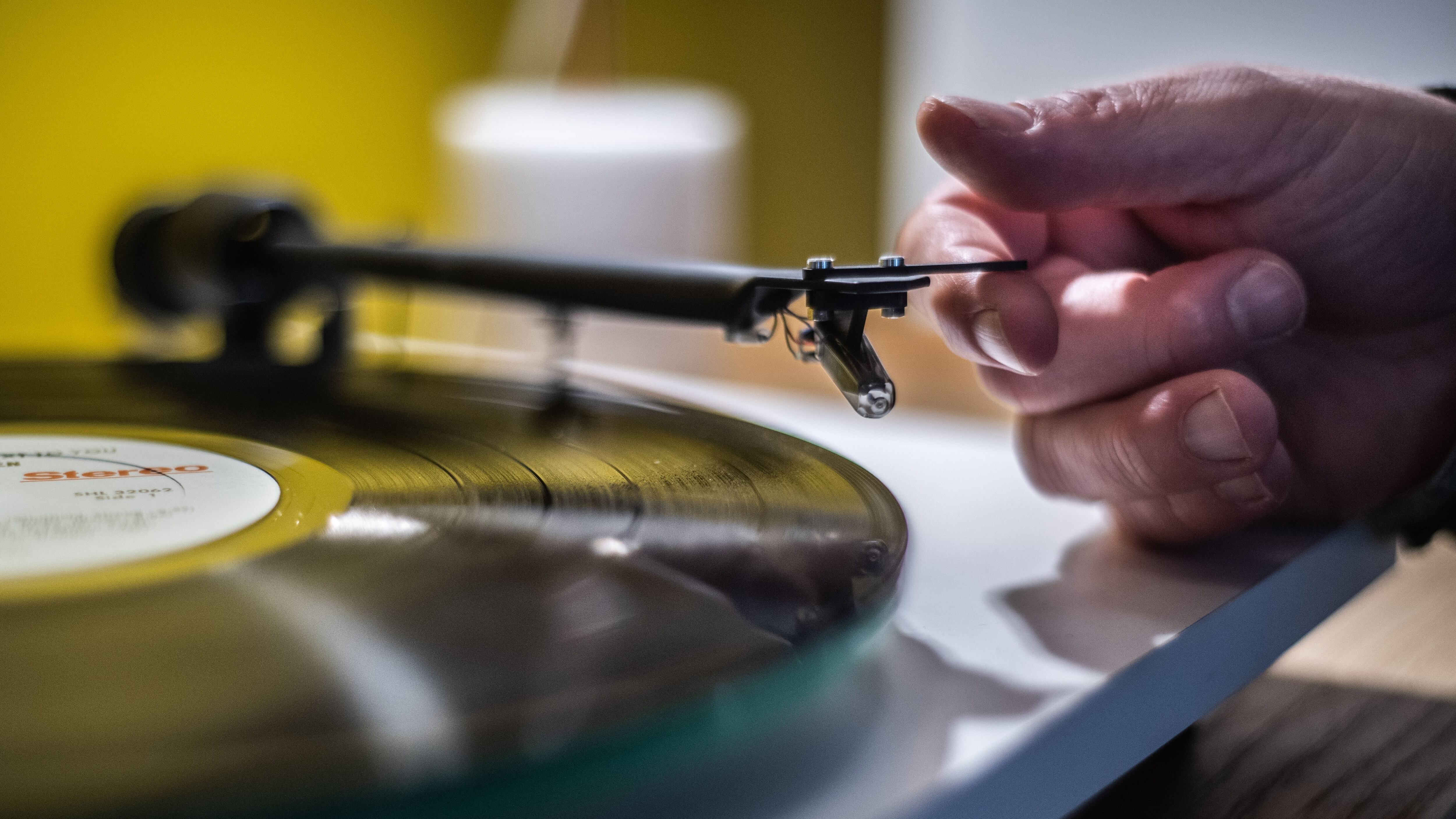 A man playing a turntable vinyl record player  in a  music store in Paris, on February 18, 2020. (Photo by Martin BUREAU / AFP) (Photo by MARTIN BUREAU/AFP via Getty Images)