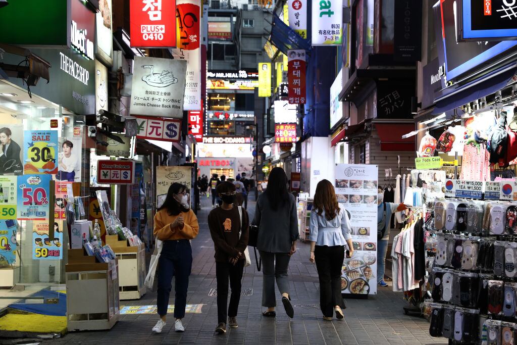 SEOUL, SOUTH KOREA - MAY 06: People walk along the street in face masks on May 06, 2020 in Seoul, South Korea. South Korea returned largely to normal as citizens return to their daily routines under eased guidelines and museums and libraries reopened under eased social distancing rules as the number of new coronavirus (COVID-19) infections has stayed low for weeks. But health authorities are still wary of "blind spots" in the fight against the virus cluster infections and imported cases. According to the Korea Center for Disease Control and Prevention, 2 new cases were reported. The total number of infections in the nation tallies at 10,806. (Photo by Chung Sung-Jun/Getty Images)