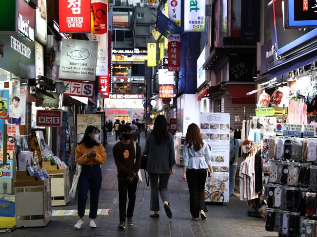 SEOUL, SOUTH KOREA - MAY 06: People walk along the street in face masks on May 06, 2020 in Seoul, South Korea. South Korea returned largely to normal as citizens return to their daily routines under eased guidelines and museums and libraries reopened under eased social distancing rules as the number of new coronavirus (COVID-19) infections has stayed low for weeks. But health authorities are still wary of "blind spots" in the fight against the virus cluster infections and imported cases. According to the Korea Center for Disease Control and Prevention, 2 new cases were reported. The total number of infections in the nation tallies at 10,806. (Photo by Chung Sung-Jun/Getty Images)