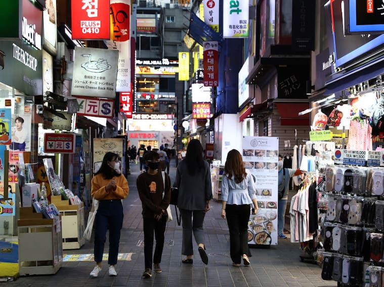 SEOUL, SOUTH KOREA - MAY 06: People walk along the street in face masks on May 06, 2020 in Seoul, South Korea. South Korea returned largely to normal as citizens return to their daily routines under eased guidelines and museums and libraries reopened under eased social distancing rules as the number of new coronavirus (COVID-19) infections has stayed low for weeks. But health authorities are still wary of "blind spots" in the fight against the virus cluster infections and imported cases. According to the Korea Center for Disease Control and Prevention, 2 new cases were reported. The total number of infections in the nation tallies at 10,806. (Photo by Chung Sung-Jun/Getty Images)