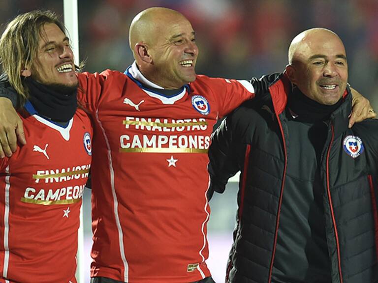 Chile's coach Jorge Sampaoli (R) celebrates with teammates after winning the 2015 Copa America football championship final against Argentina, in Santiago, Chile, on July 4, 2015. AFP PHOTO / RODRIGO ARANGUA