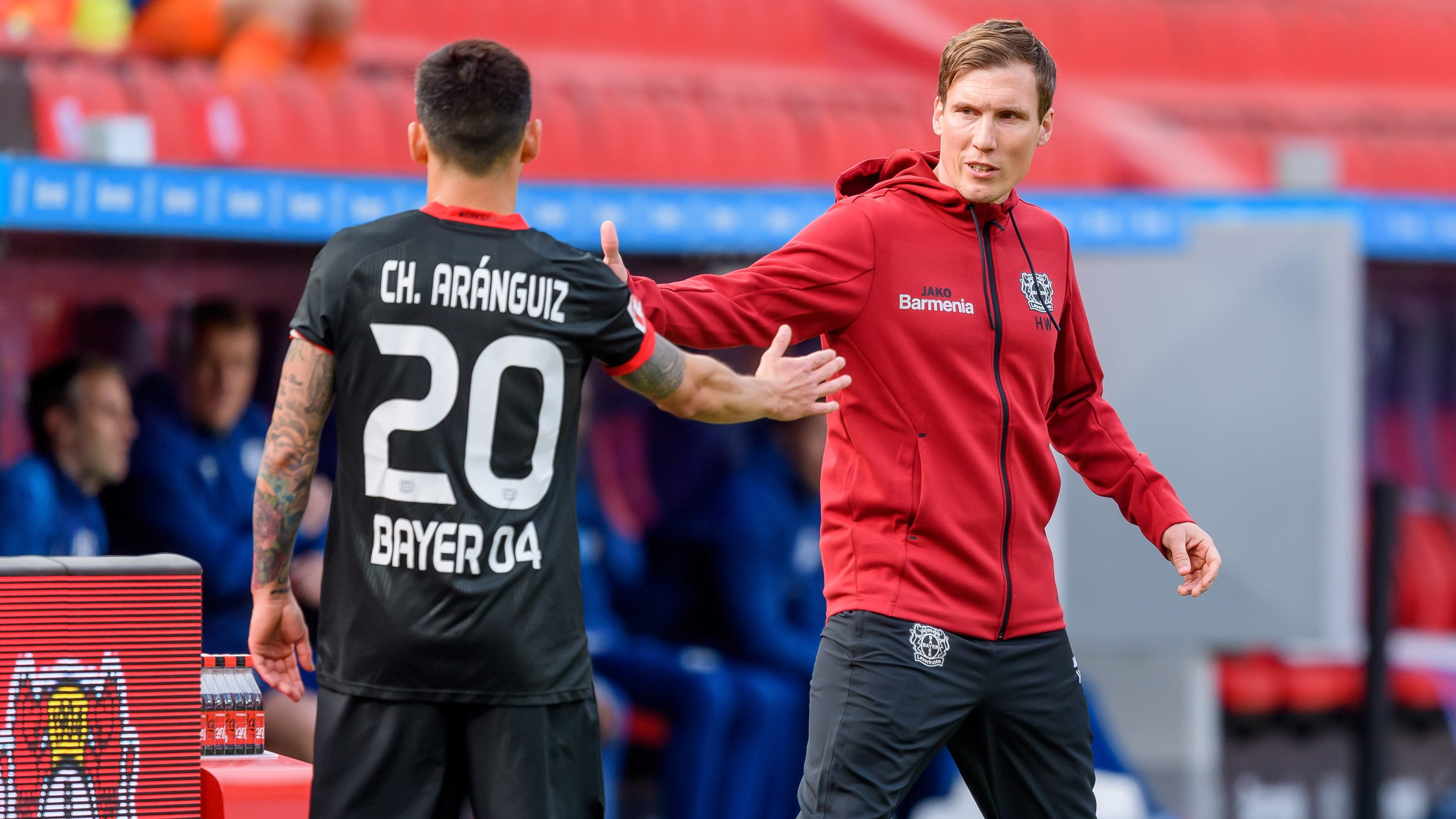 LEVERKUSEN, GERMANY - APRIL 03: (BILD ZEITUNG OUT) Charles Aranguiz of Bayer 04 Leverkusen and head coach Hannes Wolf of Bayer 04 Leverkusen look on during the Bundesliga match between Bayer 04 Leverkusen and FC Schalke 04 at BayArena on April 3, 2021 in Leverkusen, Germany. Sporting stadiums around Germany remain under strict restrictions due to the Coronavirus Pandemic as Government social distancing laws prohibit fans inside venues resulting in games being played behind closed doors. (Photo by Mario Hommes/DeFodi Images via Getty Images)