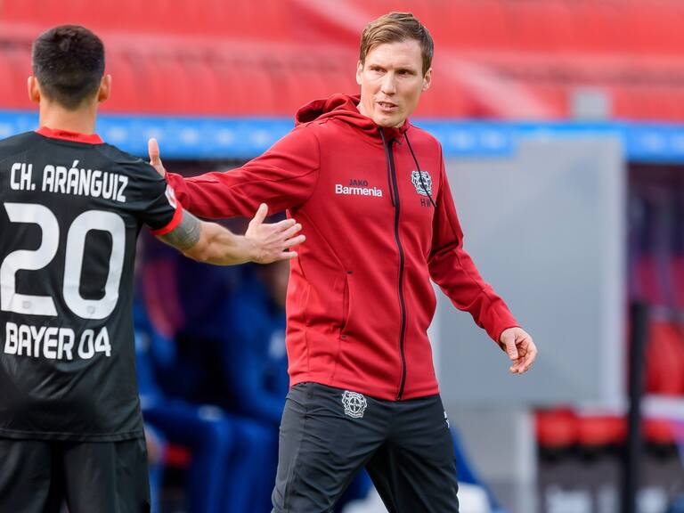 LEVERKUSEN, GERMANY - APRIL 03: (BILD ZEITUNG OUT) Charles Aranguiz of Bayer 04 Leverkusen and head coach Hannes Wolf of Bayer 04 Leverkusen look on during the Bundesliga match between Bayer 04 Leverkusen and FC Schalke 04 at BayArena on April 3, 2021 in Leverkusen, Germany. Sporting stadiums around Germany remain under strict restrictions due to the Coronavirus Pandemic as Government social distancing laws prohibit fans inside venues resulting in games being played behind closed doors. (Photo by Mario Hommes/DeFodi Images via Getty Images)