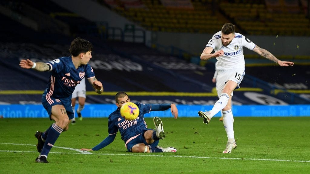 LEEDS, ENGLAND - NOVEMBER 22: Stuart Dallas of Leeds United (R) has a shot past Dani Ceballos of Arsenal (C) during the Premier League match between Leeds United and Arsenal at Elland Road on November 22, 2020 in Leeds, England. Sporting stadiums around the UK remain under strict restrictions due to the Coronavirus Pandemic as Government social distancing laws prohibit fans inside venues resulting in games being played behind closed doors. (Photo by Michael Regan/Getty Images)