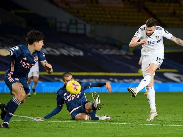 LEEDS, ENGLAND - NOVEMBER 22: Stuart Dallas of Leeds United (R) has a shot past Dani Ceballos of Arsenal (C) during the Premier League match between Leeds United and Arsenal at Elland Road on November 22, 2020 in Leeds, England. Sporting stadiums around the UK remain under strict restrictions due to the Coronavirus Pandemic as Government social distancing laws prohibit fans inside venues resulting in games being played behind closed doors. (Photo by Michael Regan/Getty Images)