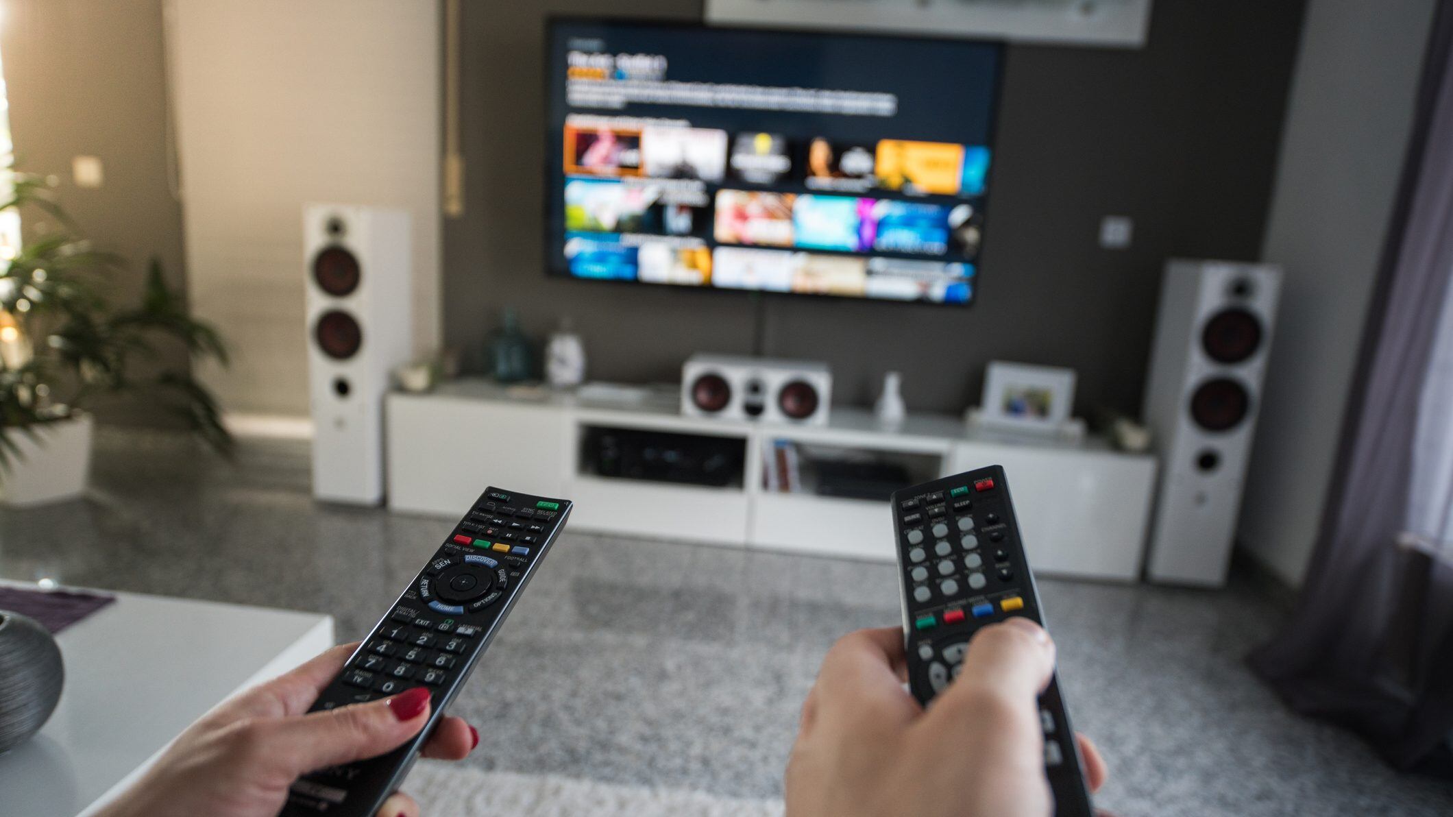 Inside a livingroom there is a battle going on about who is in charge of the television channels.