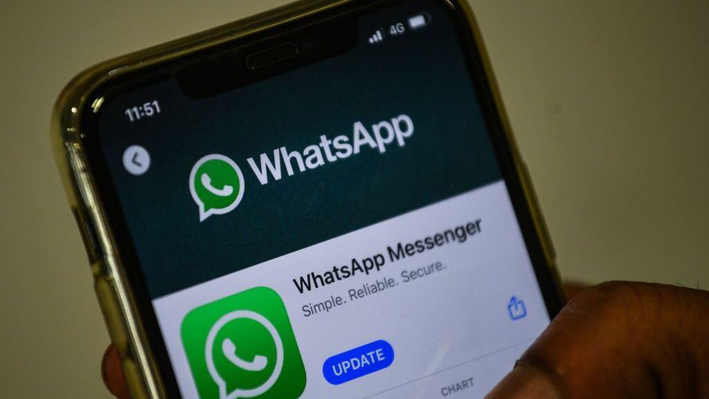 In this photo illustration taken on November 6, 2020, a user updates Facebook's WhatsApp application on his mobile phone in Mumbai. - WhatsApp on November 6 entered an increasingly tense battle between multi-national giants such as Google and AliBaba for a chunk of India's fast growing digital payments market. (Photo by Indranil MUKHERJEE / AFP) (Photo by INDRANIL MUKHERJEE/AFP via Getty Images)