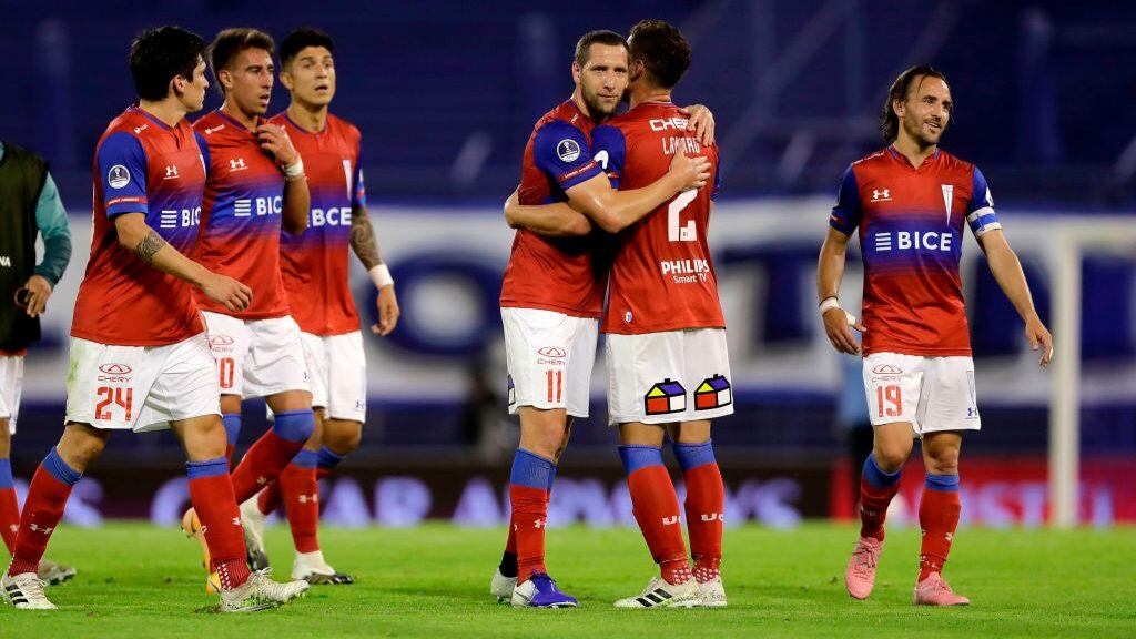 Players of Chile's Universidad Catolica celebrate after defeating Argentina's Velez Sarsfield 2-1 in a Copa Sudamericana quarterfinal football match at the Jose Amalfitani Stadium in Liniers, Buenos Aires, on December 8, 2020. (Photo by Juan Ignacio RONCORONI / POOL / AFP) (Photo by JUAN IGNACIO RONCORONI/POOL/AFP via Getty Images)