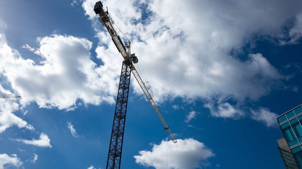 Construction crane silhouetted against a cloudy blue sky in the Mission Bay/Potrero Hill neighborhood of San Francisco, California, October 18, 2016. Mission Bay, one of the newest neighborhoods in San Francisco, is undergoing extensive construction. (Photo via Smith Collection/Gado/Getty Images).