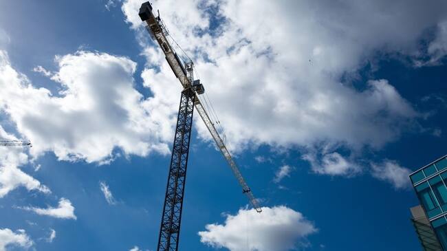 Construction crane silhouetted against a cloudy blue sky in the Mission Bay/Potrero Hill neighborhood of San Francisco, California, October 18, 2016. Mission Bay, one of the newest neighborhoods in San Francisco, is undergoing extensive construction. (Photo via Smith Collection/Gado/Getty Images).