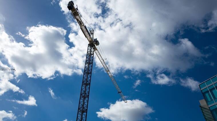 Construction crane silhouetted against a cloudy blue sky in the Mission Bay/Potrero Hill neighborhood of San Francisco, California, October 18, 2016. Mission Bay, one of the newest neighborhoods in San Francisco, is undergoing extensive construction. (Photo via Smith Collection/Gado/Getty Images).