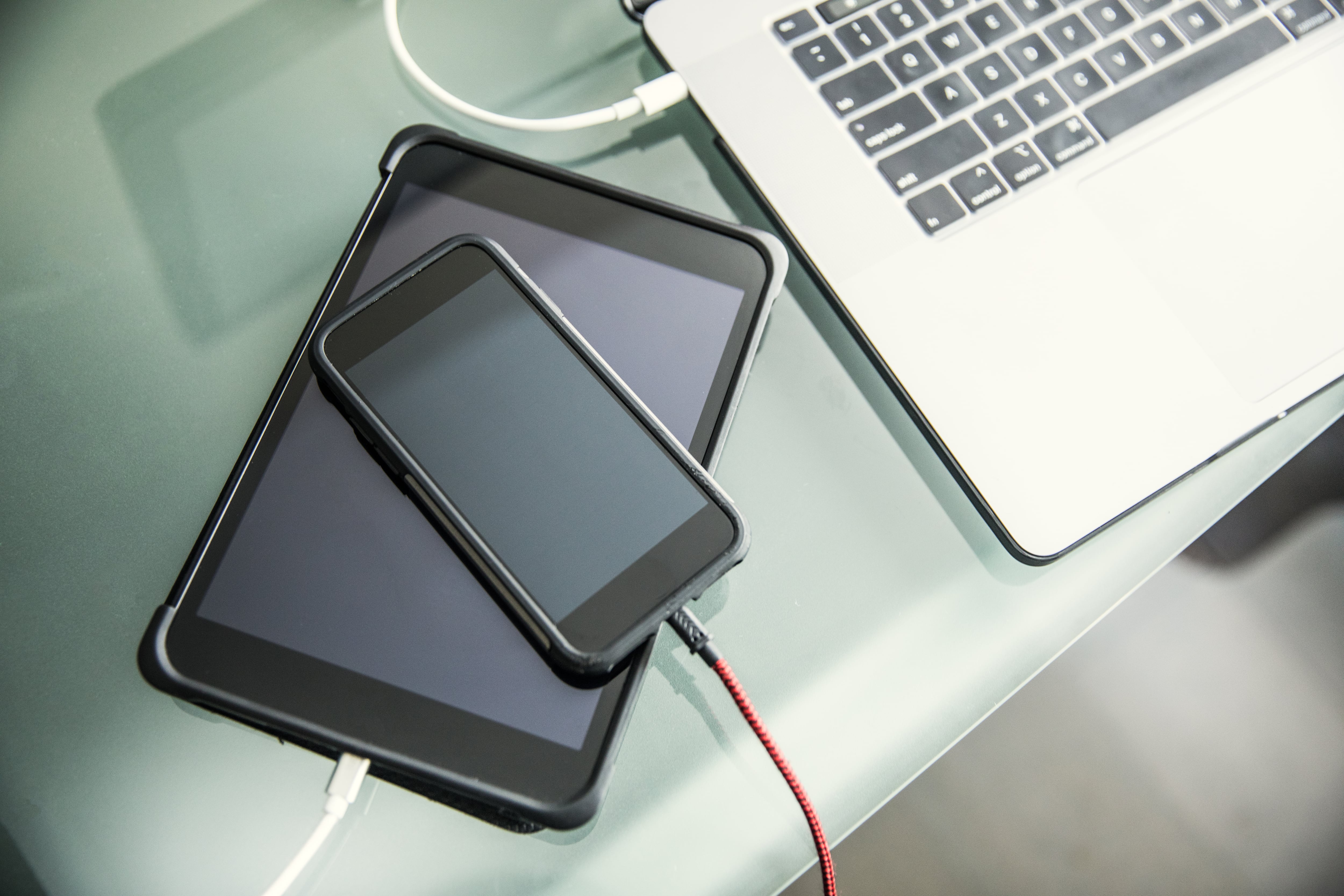 Mobile devices and laptop charging on office desk