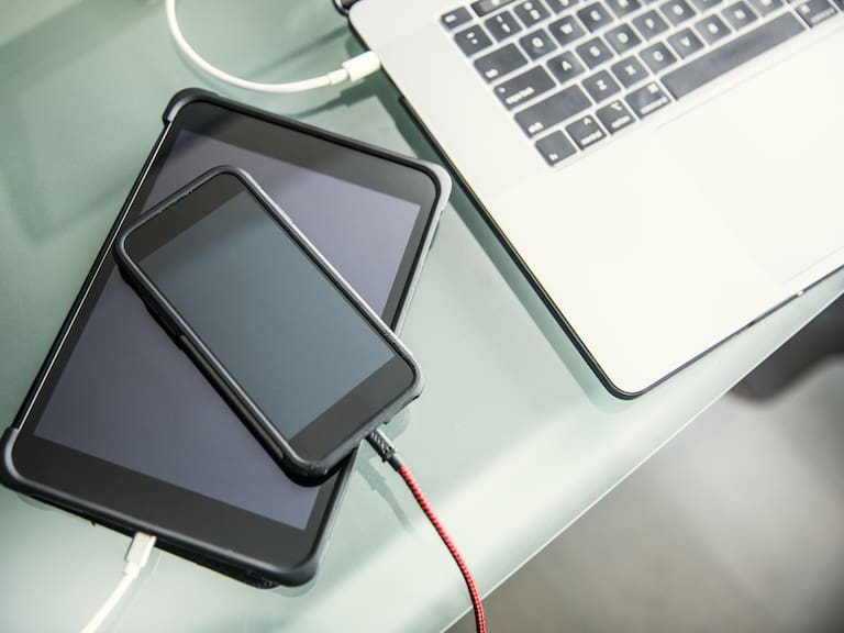 Mobile devices and laptop charging on office desk