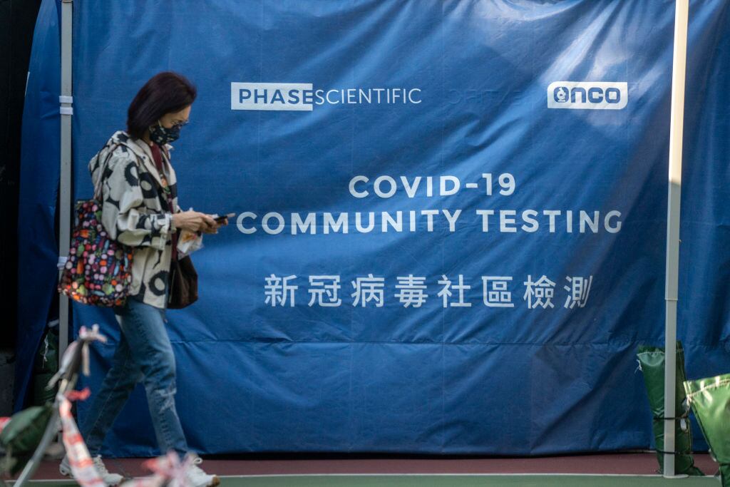A women walks pass a tent at Covid-19 testing center on January 19, 2023 in Hong Kong, China. The Chinese New Years of Lunar New Years Holiday starts next week, this year is the Year of the Rabbit in the Chinese Zodiac Calendar, China requires People entering the country to produce a negative PCR Covid-19 test. (Photo by Vernon Yuen/NurPhoto via Getty Images)