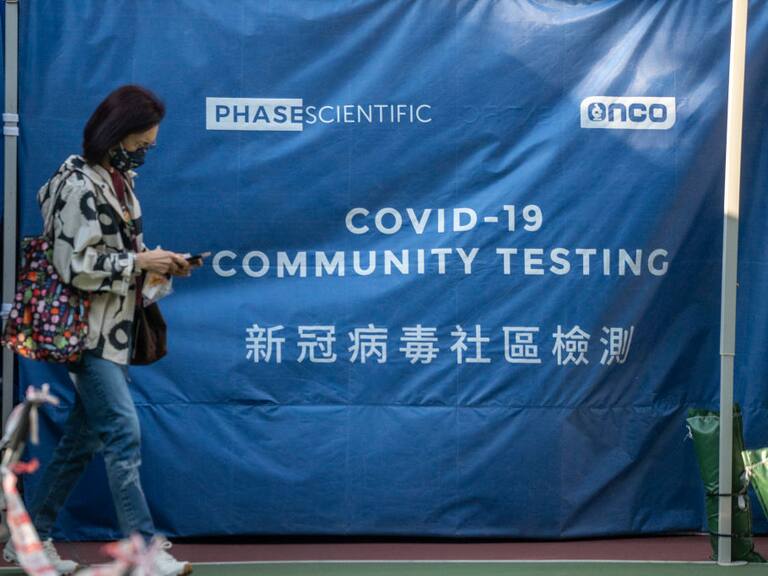 A women walks pass a tent at Covid-19 testing center on January 19, 2023 in Hong Kong, China. The Chinese New Years of Lunar New Years Holiday starts next week, this year is the Year of the Rabbit in the Chinese Zodiac Calendar, China requires People entering the country to produce a negative PCR Covid-19 test. (Photo by Vernon Yuen/NurPhoto via Getty Images)