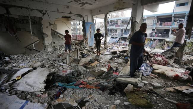 Palestinos buscan entre los escombros en la escuela de la UNRWA en Gaza que fue bombardeada por Israel.