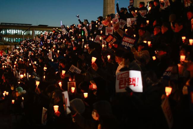 Manifestantes en Corea del Sur protestan frente al parlamento contra el presidente Yoon Suk Yeol, luego que fracasara su intento de aplicar la Ley Marcial